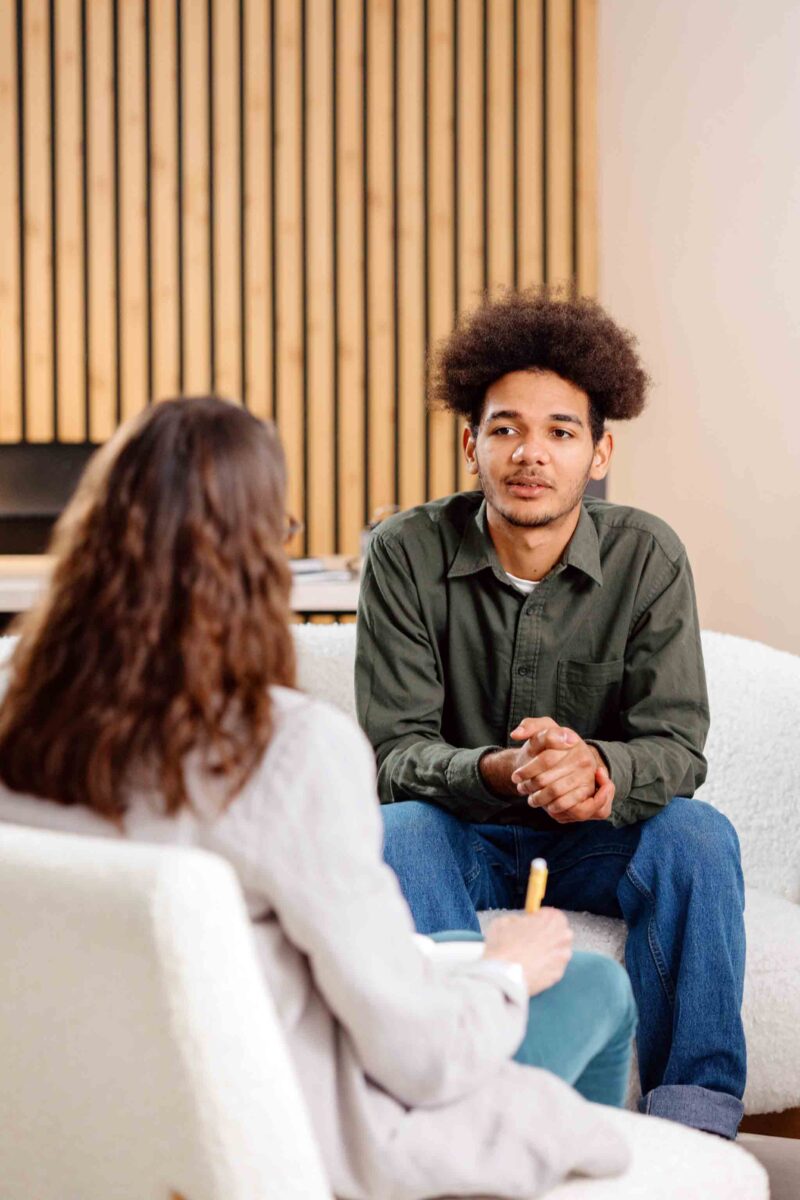 young man meeting with a therapist in detox and rehab before sober living