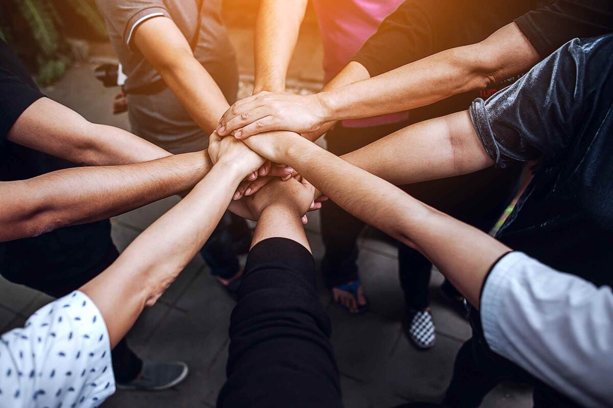 hands coming together in teamwork for building structure in recovery